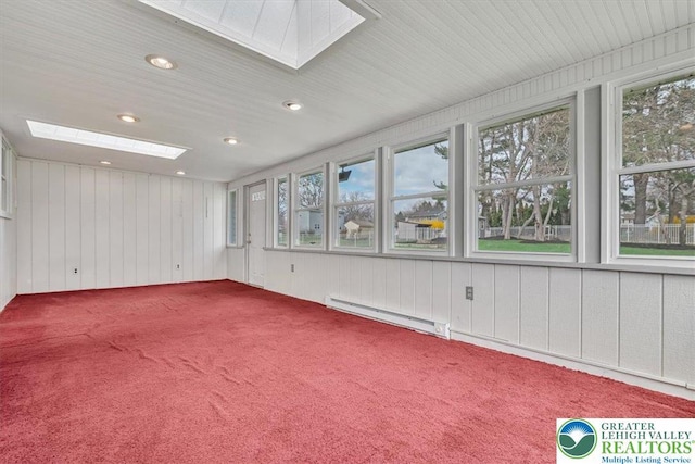 unfurnished sunroom featuring baseboard heating and a skylight