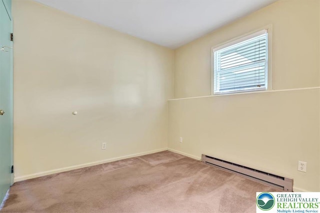 spare room featuring carpet flooring, baseboard heating, and baseboards
