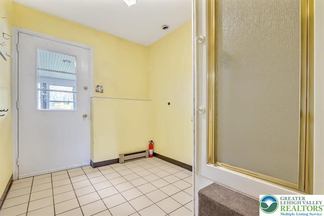 doorway to outside with light tile patterned floors, a baseboard radiator, and baseboards
