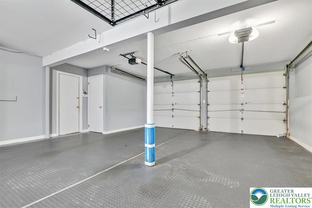 garage with baseboards and a garage door opener