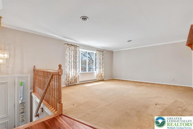 spare room featuring a notable chandelier, baseboards, ornamental molding, carpet flooring, and visible vents