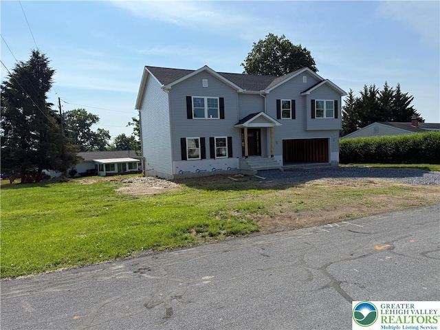 5743 Crescent Dr, North Whitehall Twp, PA 18078 - traditional-style home with dirt driveway, an attached garage, and a front lawn
