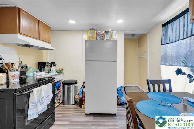 231 W Abbott St, Lansford Borough, PA 18232 - kitchen featuring freestanding refrigerator, brown cabinetry, light wood-type flooring, under cabinet range hood, and black range with electric stovetop