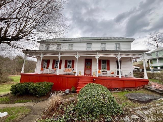 view of front of property with covered porch and metal roof
