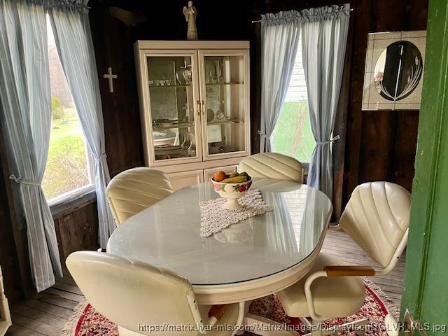 dining area with wood finished floors and a healthy amount of sunlight