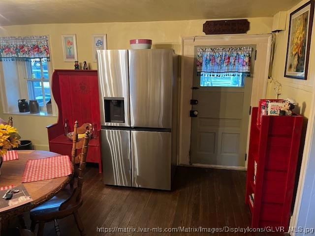 kitchen featuring stainless steel fridge with ice dispenser and dark wood-style flooring
