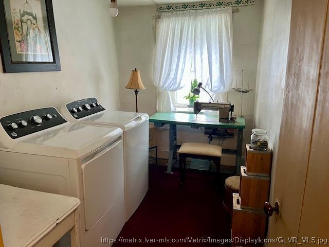 clothes washing area with laundry area and washer and clothes dryer