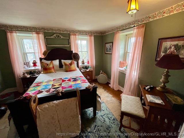 tiled bedroom featuring baseboards