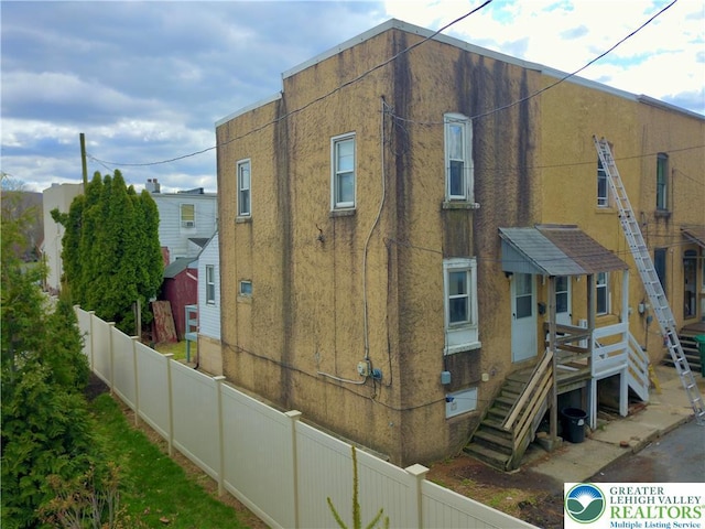 view of property with fence