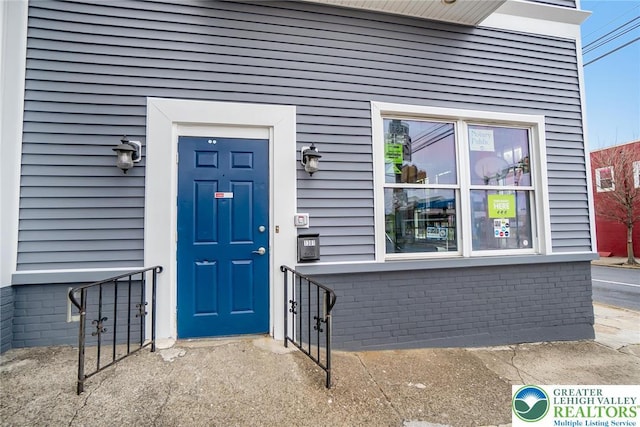 entrance to property with brick siding