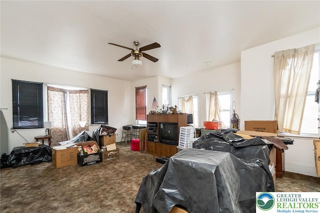carpeted living room featuring a ceiling fan