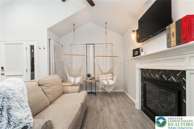 5112 Creek Rd, Heidelberg Twp, PA 18078 - living area featuring baseboards, light wood-type flooring, a fireplace, and lofted ceiling