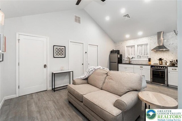 5112 Creek Rd, Heidelberg Twp, PA 18078 - living room with high vaulted ceiling, light wood finished floors, visible vents, and baseboards