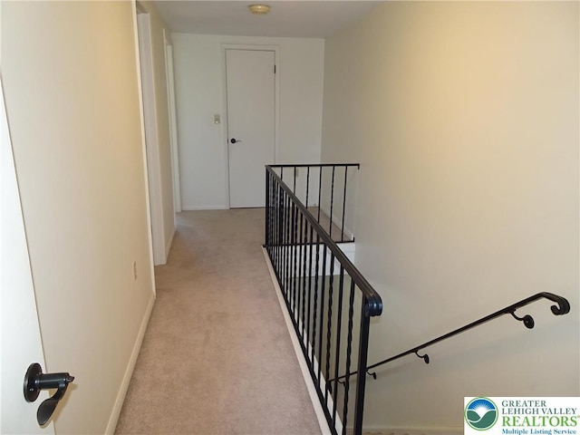 stairway with carpet floors and baseboards