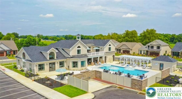 exterior space with a pergola, a fenced backyard, a fenced in pool, and a balcony