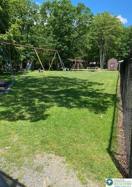 71 Dogwood Dr, Penn Forest Township, PA 18229 - view of yard with an outdoor structure, a playground, and a shed