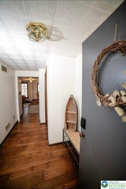 71 Dogwood Dr, Penn Forest Township, PA 18229 - corridor with visible vents, an ornate ceiling, and wood finished floors