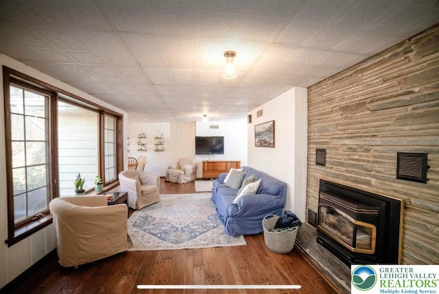 71 Dogwood Dr, Penn Forest Township, PA 18229 - living area with wood walls, a fireplace, visible vents, and hardwood / wood-style flooring