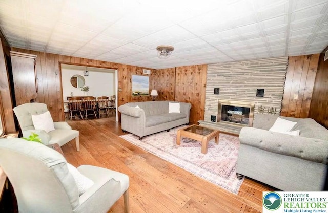 71 Dogwood Dr, Penn Forest Township, PA 18229 - living room featuring wood walls, wood finished floors, and a fireplace