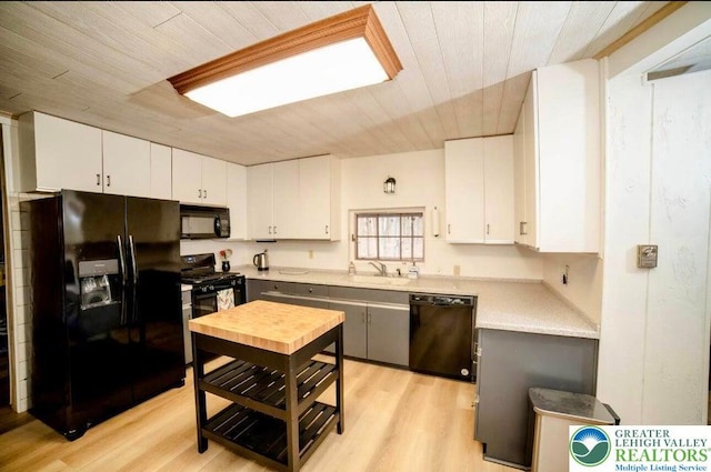 71 Dogwood Dr, Penn Forest Township, PA 18229 - kitchen with light countertops, wood ceiling, black appliances, and white cabinetry
