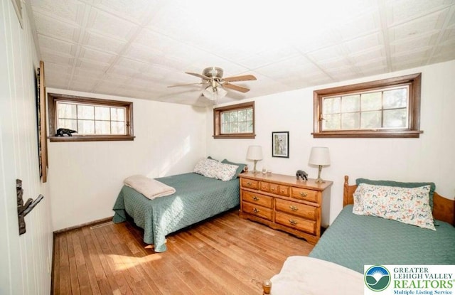 71 Dogwood Dr, Penn Forest Township, PA 18229 - bedroom featuring light wood finished floors, multiple windows, and a ceiling fan