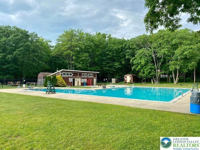71 Dogwood Dr, Penn Forest Township, PA 18229 - pool with an outbuilding, a storage shed, fence, and a lawn