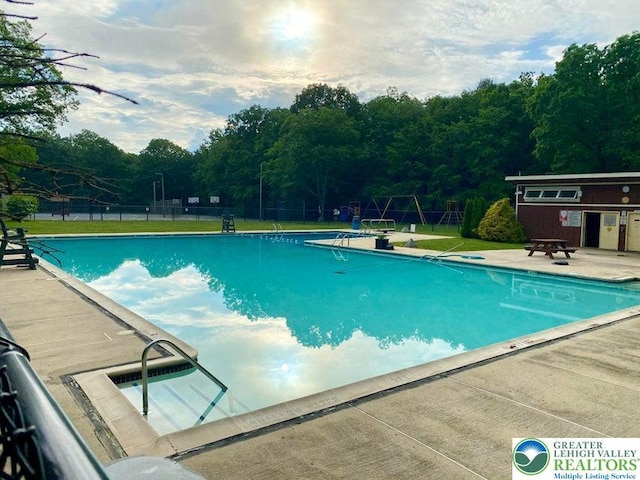 71 Dogwood Dr, Penn Forest Township, PA 18229 - community pool featuring a patio area, fence, and a lawn