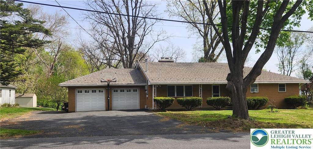 265 Mickley Rd, Whitehall Twp, PA 18052 - single story home featuring an attached garage, a chimney, driveway, and brick siding