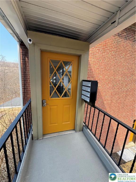 entrance to property featuring brick siding