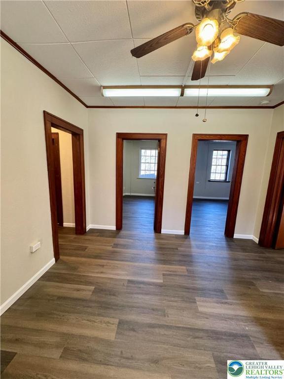 unfurnished room featuring a healthy amount of sunlight, baseboards, and a ceiling fan