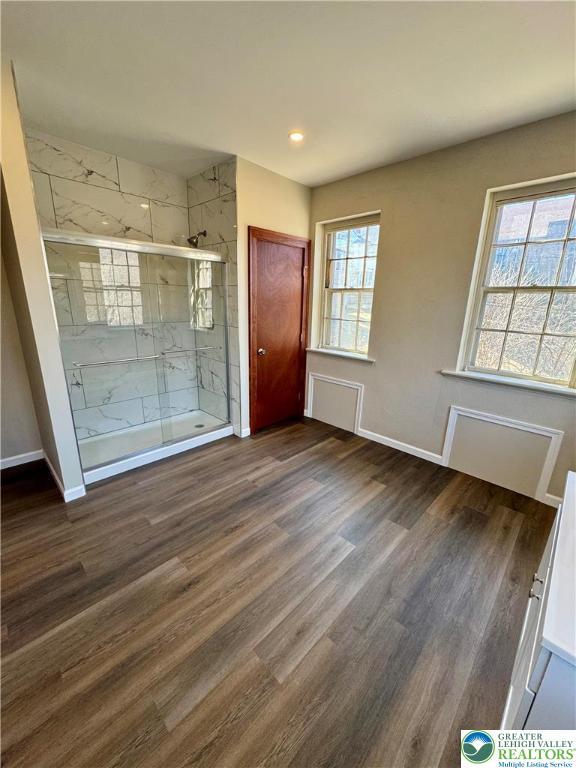 interior space featuring baseboards, recessed lighting, and wood finished floors