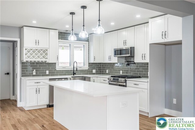 525 N Main St, Allentown City, PA 18104 - kitchen featuring appliances with stainless steel finishes, a sink, a center island, white cabinets, and recessed lighting