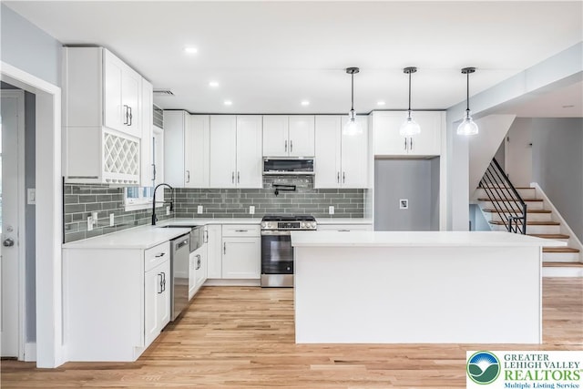 525 N Main St, Allentown City, PA 18104 - kitchen with appliances with stainless steel finishes, light wood-style flooring, a sink, backsplash, and recessed lighting