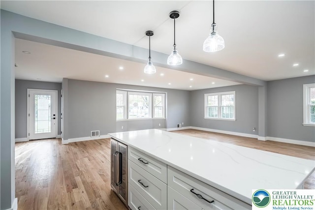 525 N Main St, Allentown City, PA 18104 - kitchen with beverage cooler, light wood-type flooring, open floor plan, white cabinetry, and baseboards