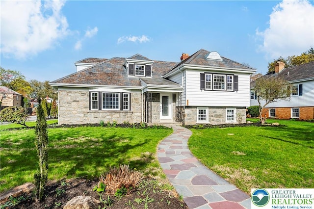 525 N Main St, Allentown City, PA 18104 - view of front facade with stone siding, a front lawn, a high end roof, and a chimney