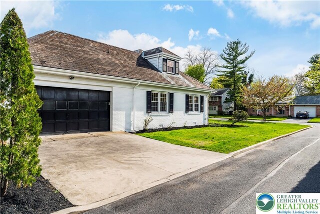525 N Main St, Allentown City, PA 18104 - view of front facade featuring driveway, a garage, a front lawn, and brick siding
