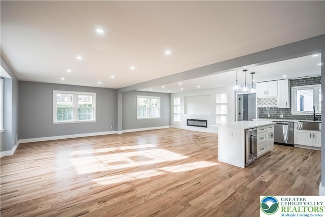 525 N Main St, Allentown City, PA 18104 - kitchen featuring stainless steel dishwasher, beverage cooler, a sink, white cabinets, and open floor plan