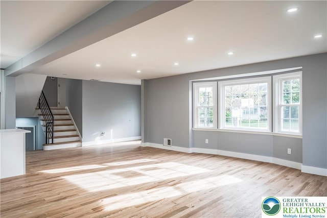 525 N Main St, Allentown City, PA 18104 - unfurnished living room featuring wood finished floors, stairway, baseboards, and recessed lighting