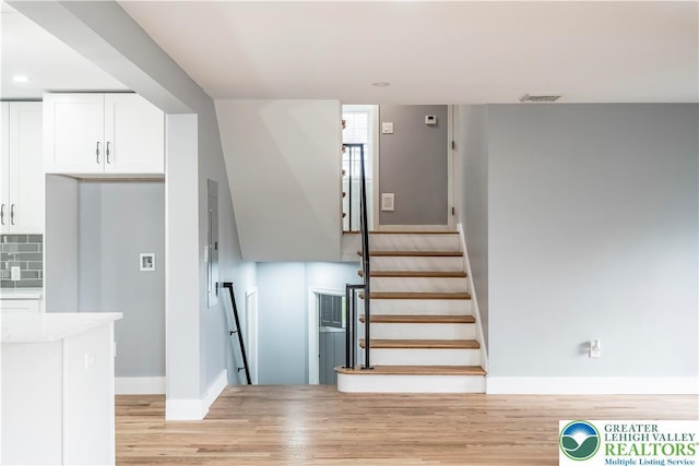 525 N Main St, Allentown City, PA 18104 - staircase featuring wood finished floors, baseboards, and recessed lighting