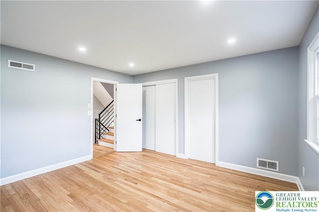 525 N Main St, Allentown City, PA 18104 - unfurnished bedroom with two closets, light wood-type flooring, baseboards, and recessed lighting