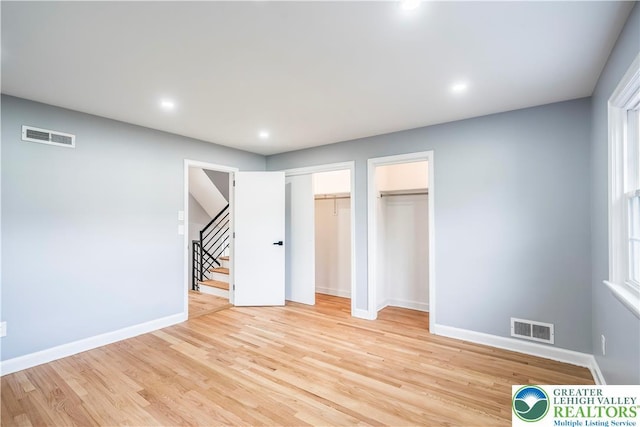 525 N Main St, Allentown City, PA 18104 - unfurnished bedroom featuring two closets, baseboards, light wood finished floors, and recessed lighting