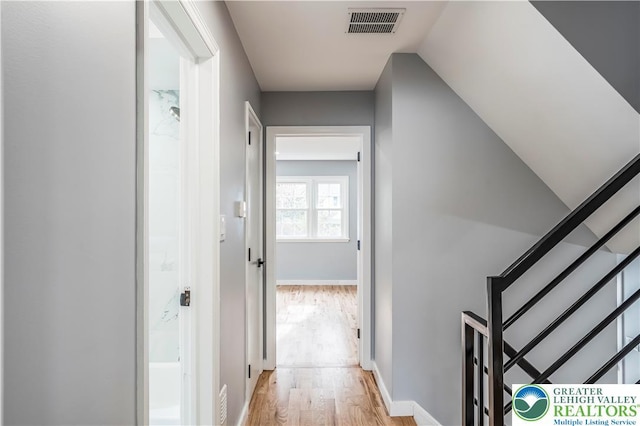 525 N Main St, Allentown City, PA 18104 - hallway featuring light wood finished floors, stairway, and baseboards