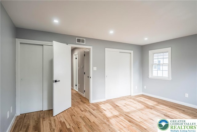 525 N Main St, Allentown City, PA 18104 - unfurnished bedroom featuring multiple closets, light wood-type flooring, baseboards, and recessed lighting
