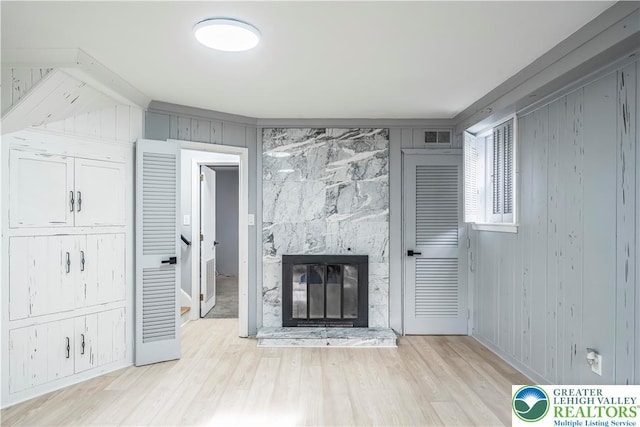 525 N Main St, Allentown City, PA 18104 - unfurnished living room featuring a large fireplace, wood finished floors, and wooden walls