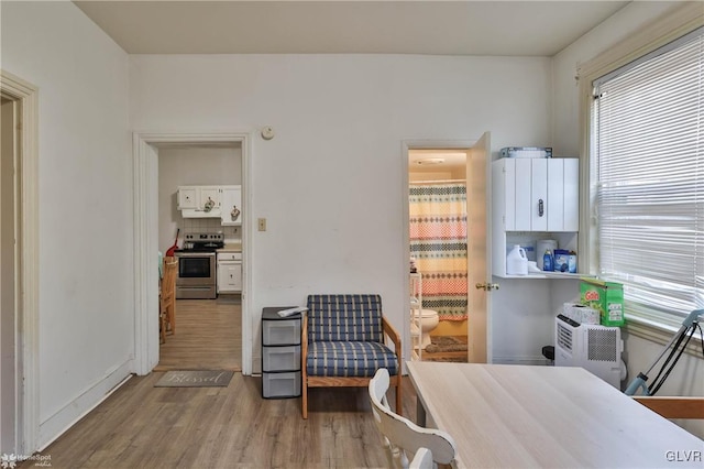 bedroom featuring wood finished floors and baseboards