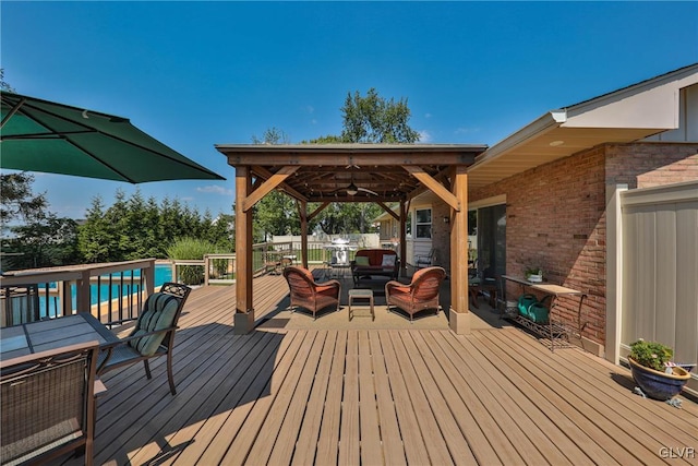 3332 Sherwood Rd, Palmer Twp, PA 18045 - wooden terrace with a gazebo, an outdoor living space, a ceiling fan, outdoor dining space, and a fenced in pool