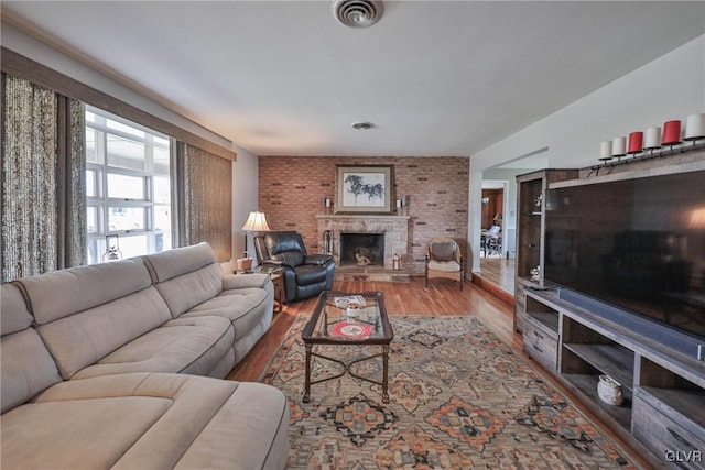 3332 Sherwood Rd, Palmer Twp, PA 18045 - living room featuring a fireplace with raised hearth, wood finished floors, and visible vents