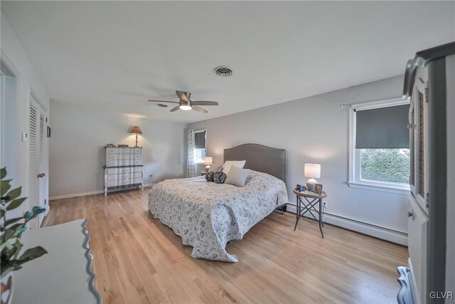 3332 Sherwood Rd, Palmer Twp, PA 18045 - bedroom featuring baseboard heating, multiple windows, visible vents, and light wood-style flooring