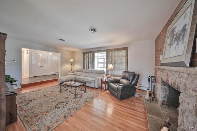 3332 Sherwood Rd, Palmer Twp, PA 18045 - living room with a baseboard heating unit, wood finished floors, visible vents, and a fireplace