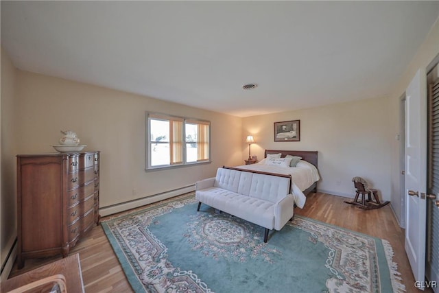 3332 Sherwood Rd, Palmer Twp, PA 18045 - bedroom with a baseboard heating unit, light wood-style flooring, visible vents, and baseboard heating